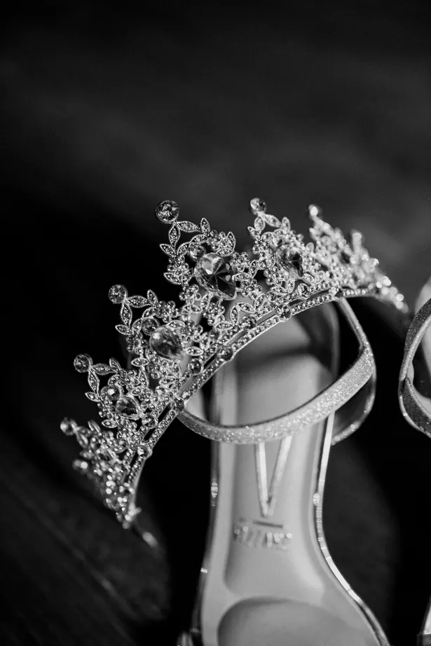 Coroa de strass apoiada no sapato, em preto e branco
